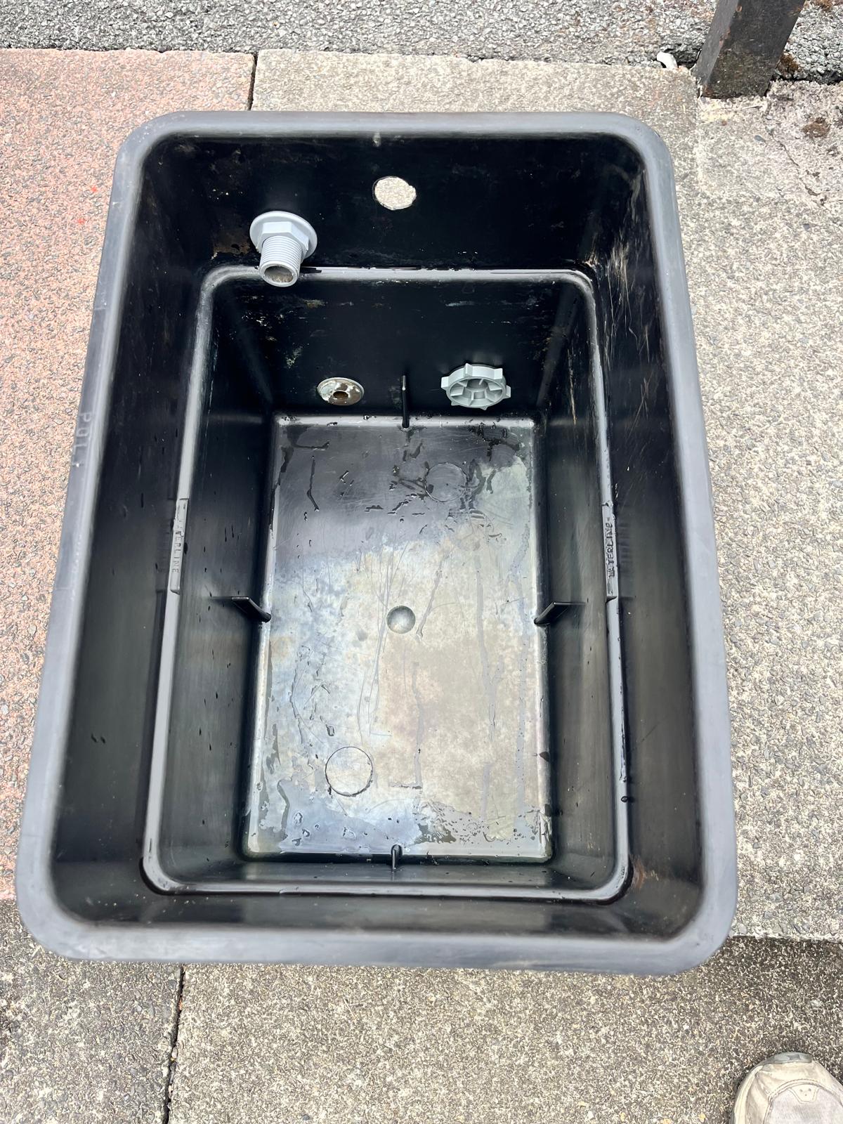 Old cold water storage tank removed during a heating system upgrade
