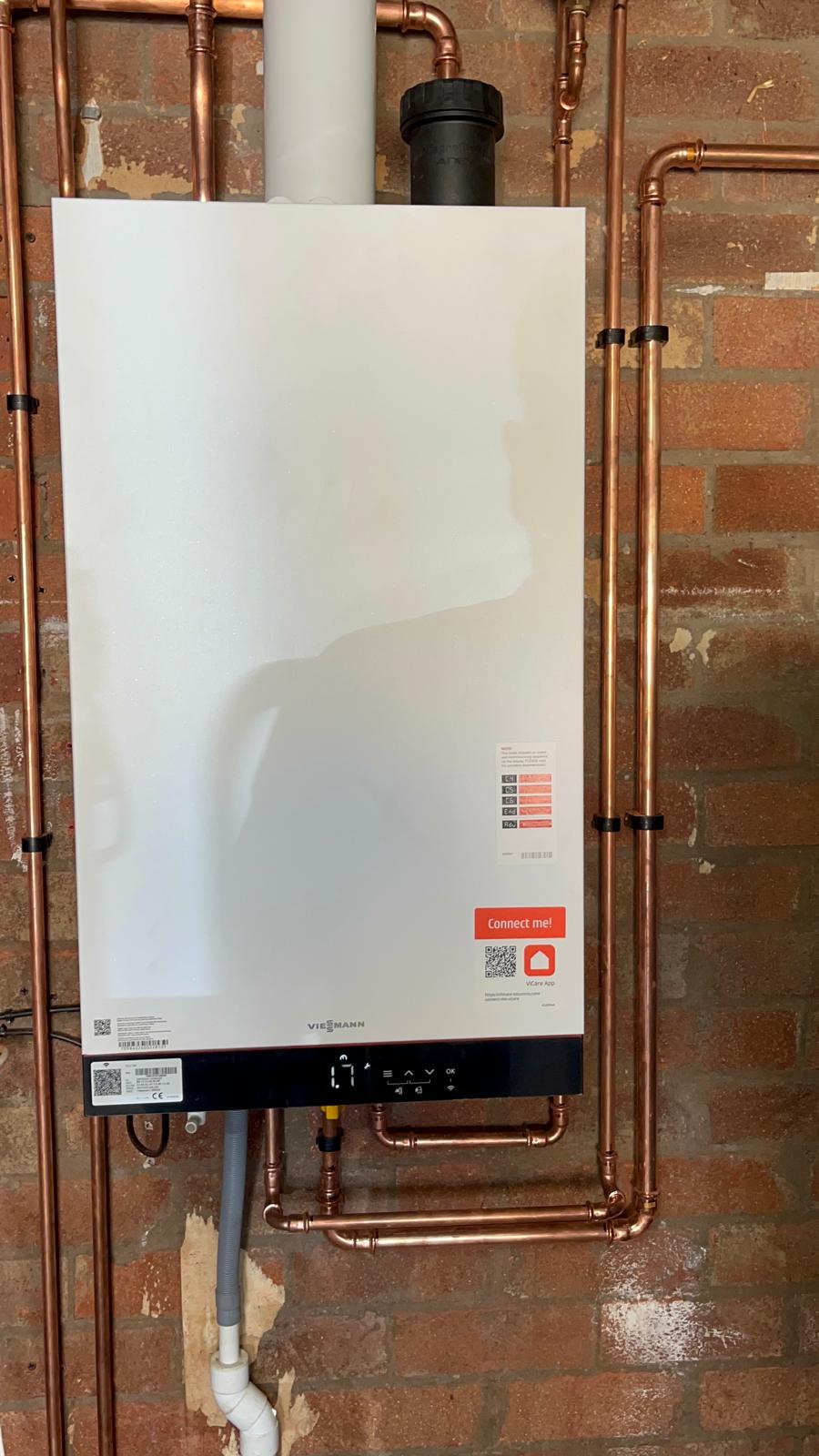 Viessmann combi boiler with condensate pipe, isolation valves and copper pipework in a cellar