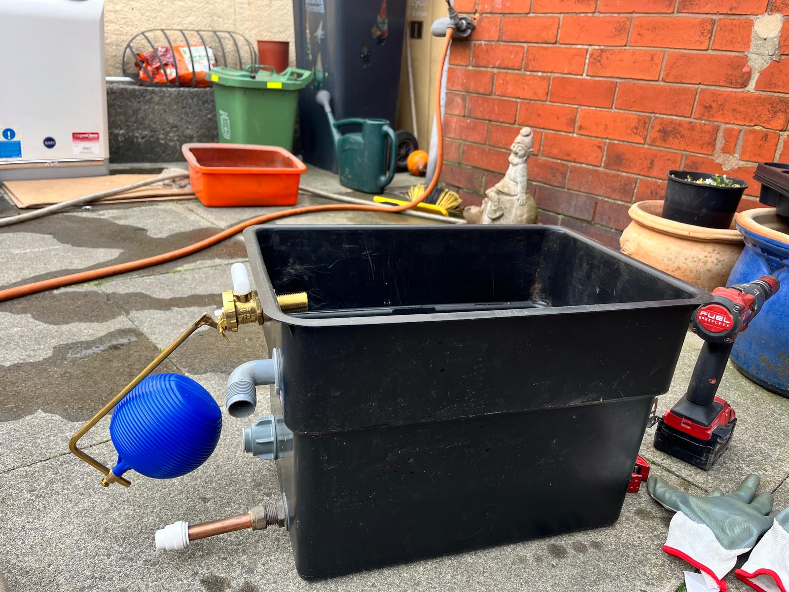 New cold water storage tank fitted with float valve, isolation valve and overflow connections
