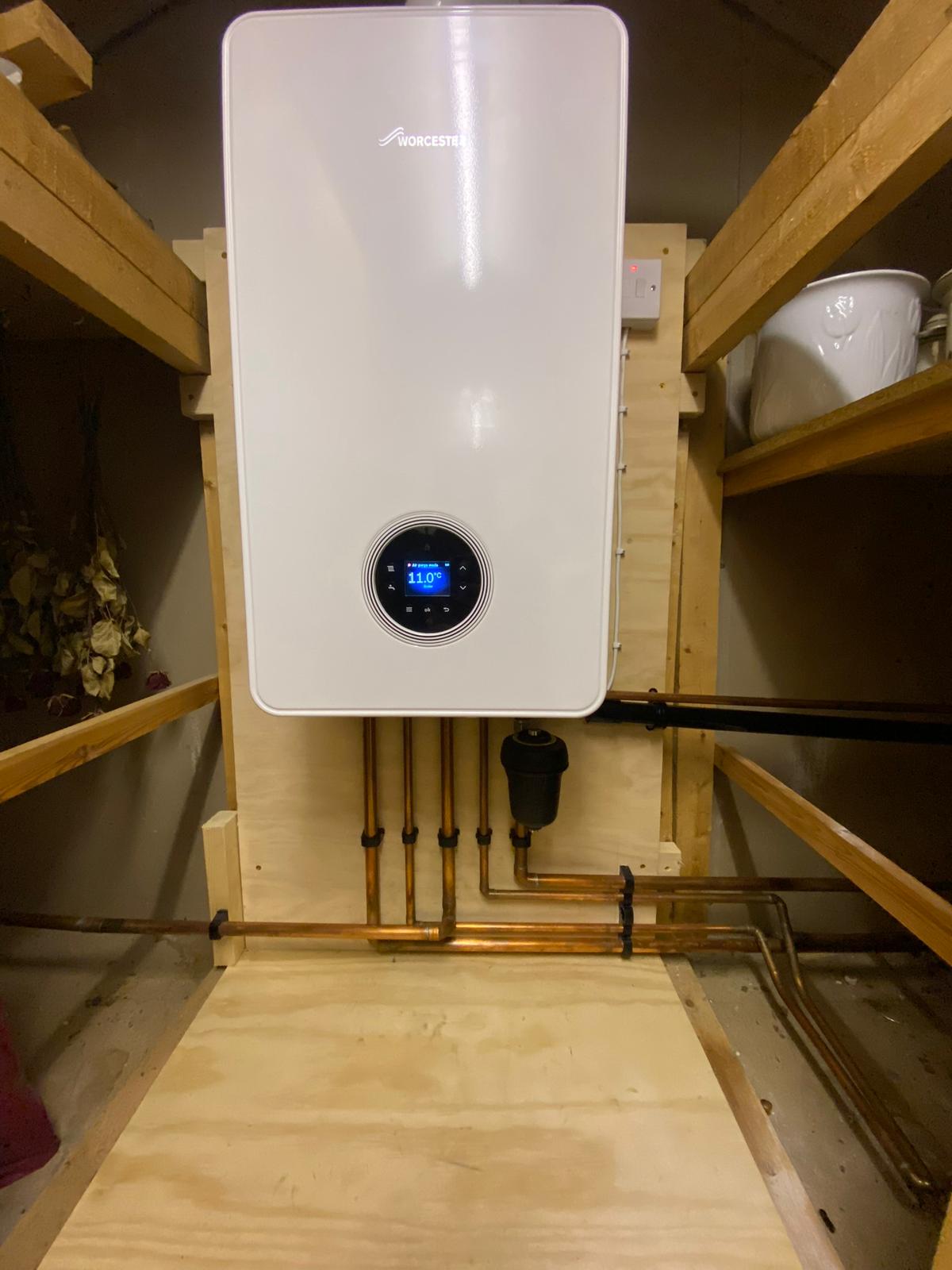 Worcester Bosch combi boiler installation with copper pipework in a home cupboard