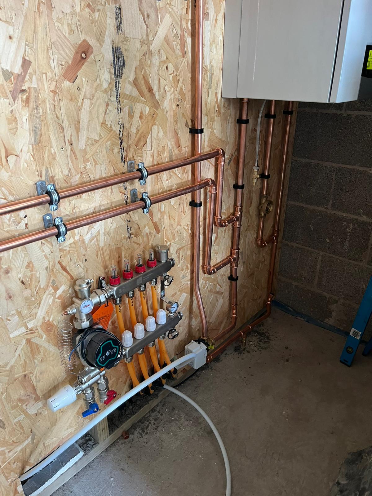Underfloor heating manifold with copper pipework and boiler connections